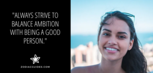 close up of a woman smiling with a quote about aquarius men liking ambitious women with a good heart